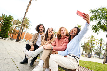 Wall Mural - Beautiful woman taking selfie with a friends. Group of multi-ethnic young people - happy smiling selfie. High quality photo