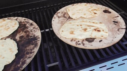 Wall Mural - Cooking flatbread on outdoor gas grill.