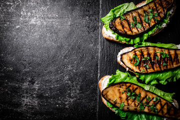 Poster - Grilled eggplant sandwich on a stone board. 