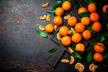 Wall Mural - Fragrant fresh tangerines on a cutting board. 