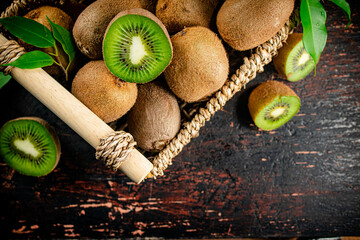 Sticker - Fresh kiwi with leaves in a basket. 