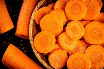 Wall Mural - Round pieces of fresh carrots on a plate. 