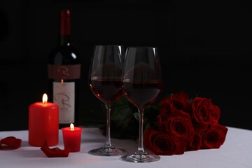 Sticker - Romantic table setting with glasses of red wine, rose flowers and burning candles