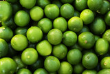 Fresh ripe green limes as background, top view
