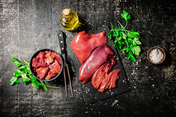 Poster - Raw liver on a stone board with parsley. 