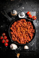 Wall Mural - Bolognese sauce on a stone board with spices, garlic and tomatoes. 