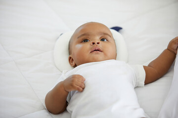 Wall Mural - cute African baby lying on the bedroom