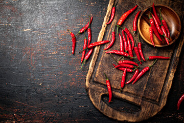 Poster - Red chili pepper pods on a cutting board.