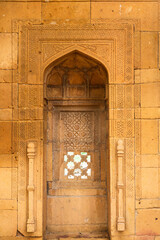 Wall Mural - Thatta, Sindh, Pakistan - October 2021: Beautiful traditional intricate geometric and floral carved stone detail, decoration, in a royal mausoleum in Makli necropolis