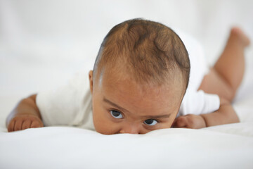 Wall Mural - portrait cute baby crawling and looking to something on bedroom