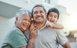 © Coetzee/peopleimages.com - Grandparents, hug and child with smile for happy holiday or weekend break with elderly people at the house. Portrait of grandma and grandpa holding little boy on back for fun playful summer together