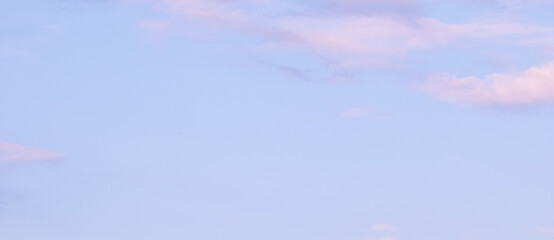 Wall Mural - blue sky background with white and pink clouds at sunset