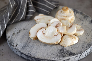 Wall Mural - champignon mushrooms sliced on a board