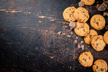 Wall Mural - Cookies with pieces of milk chocolate on the table. 