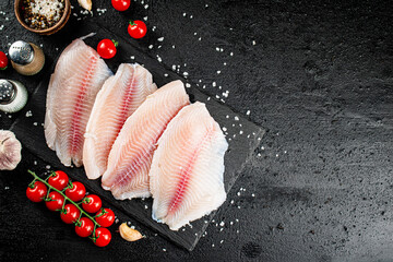 Poster - Raw fish fillet with spices and tomatoes on a stone board. 