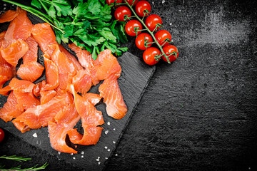 Sticker - Salted salmon on a stone board with tomatoes and greens. 