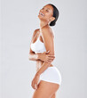 © Wesley JvR/peopleimages.com - Fitness, skincare and black woman in underwear, smile and confident girl on grey studio background. African American female, lady and healthy lifestyle with diet, body care and laughing on backdrop