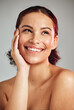 © K. A./peopleimages.com - Skincare, wellness and woman with makeup in studio with cosmetic, beauty or natural face routine. Happy, smile and female model with healthy or self care facial treatment isolated by gray background.
