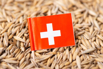 Poster - Flag of Switzerland on oat grain. Concept of growing oats in Switzerland, origin of grain