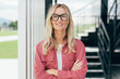 © Ilona - Testimonial portrait of a beautiful businesswoman standing with her arms crossed.