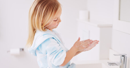 Wall Mural - Girl washing her hands in the bathroom of her home for hygiene, stop germs and prevent bacteria. Healthcare, clean and young child doing sanitary routine with soap and water in the basin at her house