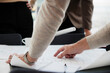 © Johnér - Hands pointing on blueprint, close-up