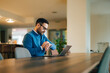 © bnenin - Businessman sitting in front of the laptop, looking at the time.