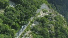 Cinematic Vertical Video Of Car Driving Up A Winding Road Through The Beklemeto In Bulgaria During The Colorful Spring Season.
