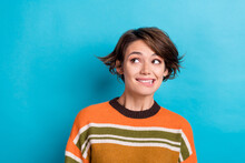 Photo Of Confused Gorgeous Girl With Short Hairstyle Dressed Striped Pullover Look Empty Space Biting Lips Isolated On Blue Color Background