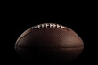 © Fokasu Art - Close up of an American football on dark background.