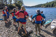 © Cavan Images - Group of people on rocky coastal beach, British Columbia, Canada