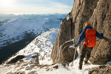 A Mountaineer Decends A Snow Covered Mountain.