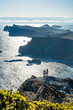 © Michael - Backpacker couple enjoying the view from a vantage point on a steep cliff overlooking the rugged foothills of Madeira's coast in the morning. Ponta do Bode, Madeira Island, Portugal, Europe.