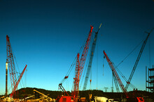 Cranes, Cement Trucks And Other Heavy Duty Equipment At Commercial Construction Site In U.S.