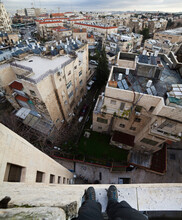 A Man Stands On The Roof Of A Hotel Looking Out Over The Surrounding City Of Jerusalem, Israel.