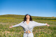 © Nanci - Front View Of A Beautiful Excited Woman Raising Her Arms And Breathing Fresh Air Celebrating Spring