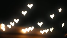Out-of-focus Lights On A Festive Heart-shaped Garland In The Background At Night