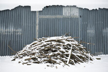 Firewood Covered In Snow Is Piled Outside A Shed On A Farm Near Kobylnica, Poland.