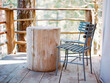 © Cavan Images - Chairs and wooden table on balcony of log cabin, Vancouver, British Columbia, Canada