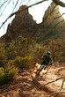 © Cavan Images - A young man rides a mountain bike downhill in the red rock of Sedona, Arizona.