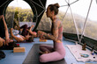 © Tessy Morelli/Stocksy - Yoga retreat morning practice