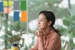 © Marc Tran/Stocksy - Businesswoman working in an office looking out of the window