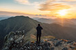 © Tatsuya Kanabe/Stocksy - Unrecognizable traveler admiring mountains at sunset