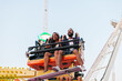 © Ezequiel Giménez/Stocksy - Cheerful man and woman on amusement ride
