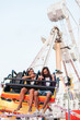 © Ezequiel Giménez/Stocksy - Couple talking on amusement ride