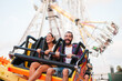 © Ezequiel Giménez/Stocksy - Excited couple on amusement ride