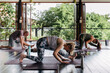 © Diane Durongpisitkul/Stocksy - People taking a cross-mat yoga class