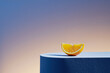 © Marc Tran/Stocksy - orange slice with hard light and shadows on podium in elegant