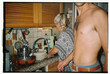 © Tessy Morelli/Stocksy - Mother and adult son in the kitchen
