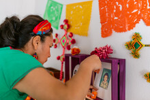 Mexican Woman Decorating Offerings Altar